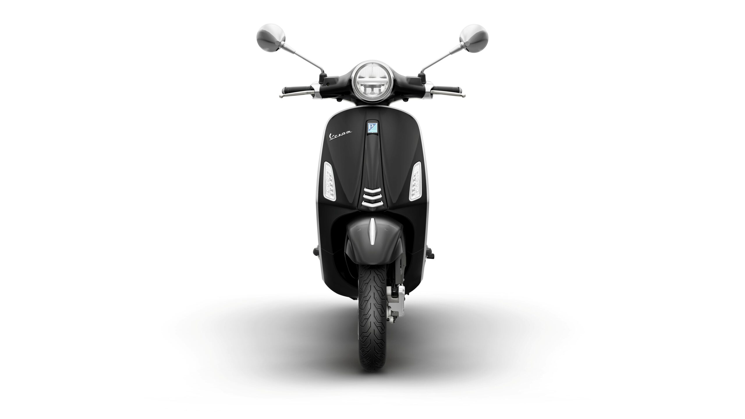 Vespa Primavera 50 MY26 Nero Convinto Front Front view of a black Vespa scooter against a white background, showcasing its classic design, round headlight, and chrome mirrors.